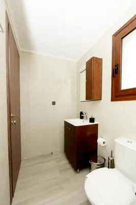 a bathroom with a toilet and a sink at Paraskevi Luxury Apartments in Kattavía