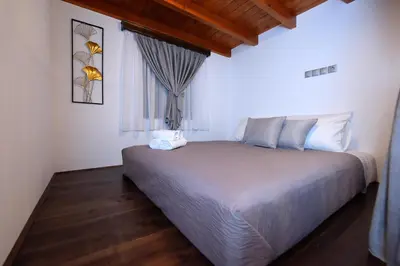 a bedroom with a large bed with a window at Paraskevi Luxury Apartments in Kattavía