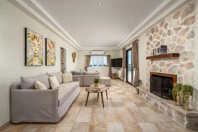 a living room with a couch and a fireplace at Villa Palmeras in Soroni