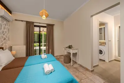 a bedroom with a blue bed with towels on it at Villa Palmeras in Soroni