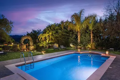 a swimming pool in a yard with a resort at Zenia Villa in Paradeísion