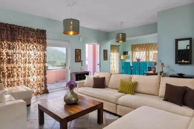 a living room with a couch and a table at Zenia Villa in Paradeísion