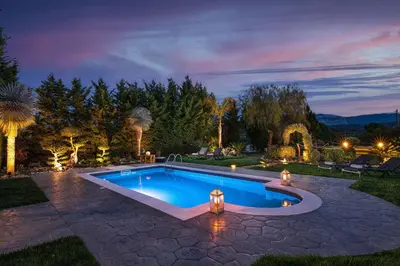 a swimming pool in a backyard at night at Zenia Villa in Paradeísion