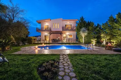 a large house with a swimming pool in the yard at Zenia Villa in Paradeísion