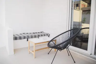 a chair and a bench on a balcony at Ladiko Inn Hotel Faliraki -Anthony Quinn Bay in Faliraki