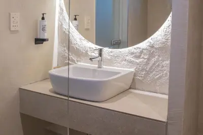 a white sink in a bathroom with a mirror at Ladiko Inn Hotel Faliraki -Anthony Quinn Bay in Faliraki
