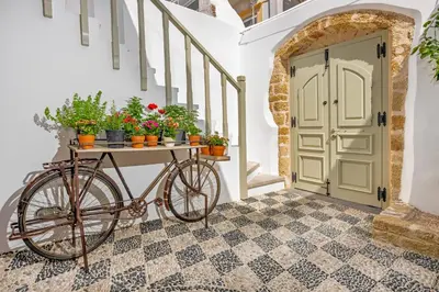 a bike parked next to a door with potted plants at Amarada City Suites in Rhodes Town