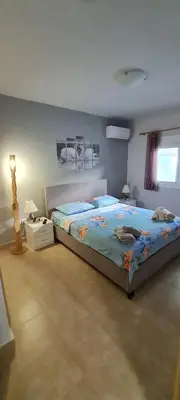 a bedroom with a large bed and a window at Annie's Apartment in Ialyssos