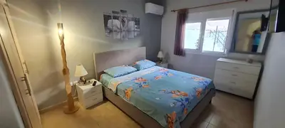 a bedroom with a bed and a dresser and a window at Annie's Apartment in Ialyssos