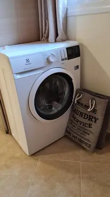 a washer and dryer with a box next to it at Annie's Apartment in Ialyssos