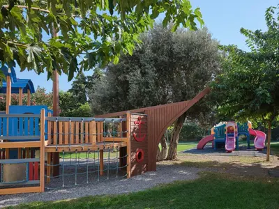 a playground with a slide in a park at Atlantica Princess Hotel in Ixia