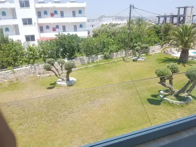 a view from a window of a yard with trees at Lilly Rooms in Faliraki