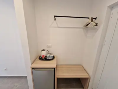 a small kitchen with a small wooden table in a room at Lilly Rooms in Faliraki