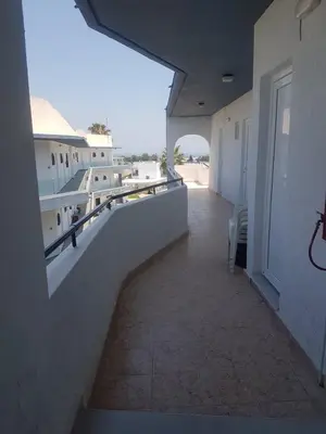 a view of a balcony of a building at Lilly Rooms in Faliraki