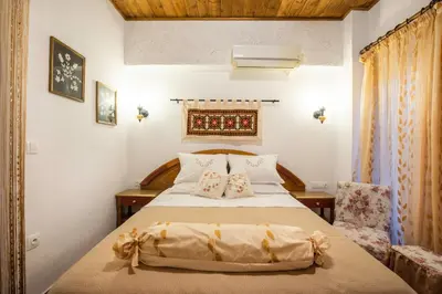 a bedroom with a large bed with two pillows at Margarita luxury apartment 2 in Faliraki