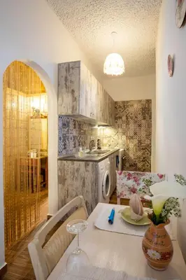 a kitchen with a table and a dining room at Margarita luxury apartment 2 in Faliraki
