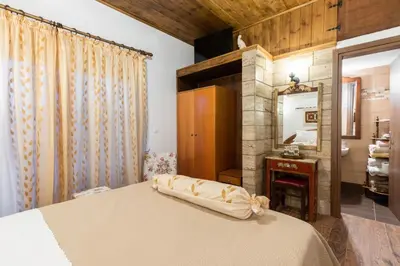 a bedroom with a bed and a mirror at Margarita luxury apartment 2 in Faliraki