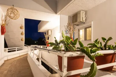 a balcony with potted plants in a house at Margarita luxury apartment 2 in Faliraki