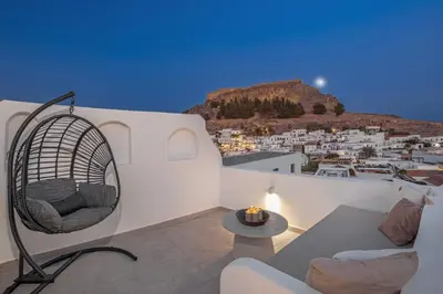 a living room with a couch and a chair at Noema Lindos - Agapitos Apartment in Líndos