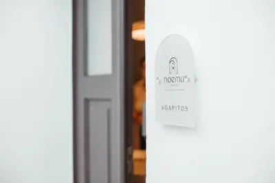 a door with a sign on the side of it at Noema Lindos - Agapitos Apartment in Líndos