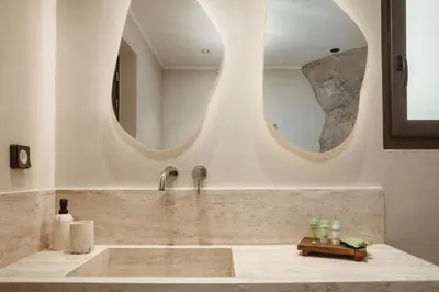 a bathroom with a sink and a mirror at Noema Lindos - Agapitos Apartment in Líndos