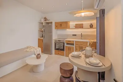 a kitchen with a table and a counter top at Noema Lindos - Agapitos Apartment in Líndos