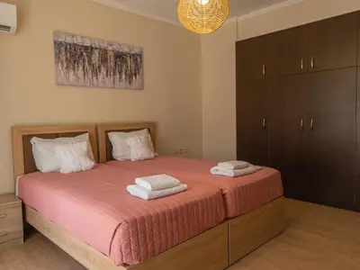 a bedroom with a bed with two towels on it at Adonis Villa in nature in Ixia