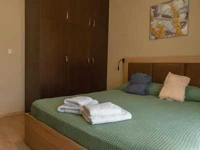a bedroom with two towels sitting on a bed at Adonis Villa in nature in Ixia