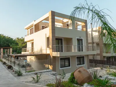a large white house with a lot of plants at Adonis Villa in nature in Ixia