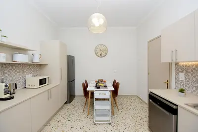 a small kitchen with a table and a microwave at Alion House in Rhodes Town