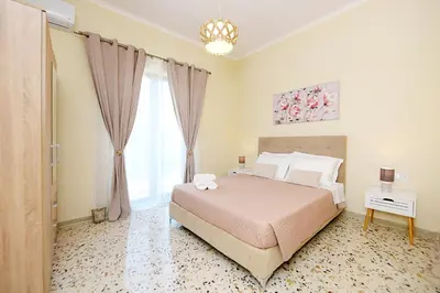 a bedroom with a large bed and a window at Alion House in Rhodes Town