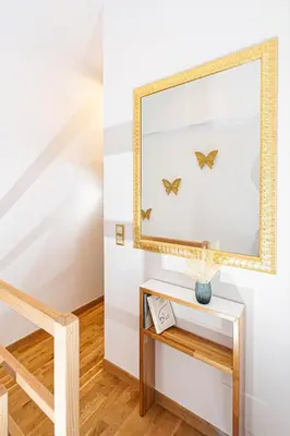 a mirror and a table with a vase on it at Villa Dafni - Lindos in Líndos