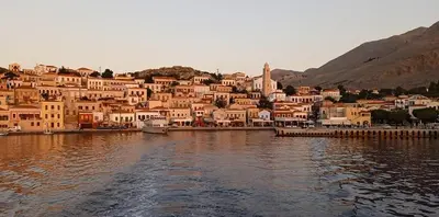 a group of houses on the shore of a body of water at Occasus Room Comfort in Halki