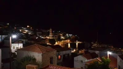 a view of a city at night with lights at Occasus Room Comfort in Halki