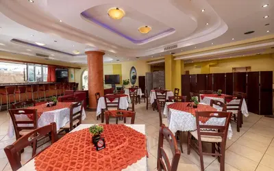 a restaurant with tables and chairs in a room at Marine Congo Hotel in Rhodes Town