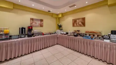 a restaurant with a long counter in a room at Marine Congo Hotel in Rhodes Town