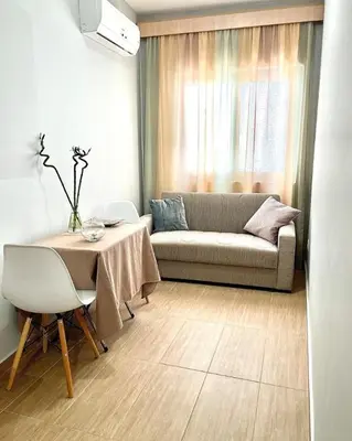 a living room with a couch and a table at Melenia Suites in Rhodes Town