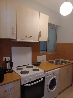 a kitchen with a stove top oven next to a sink at Melenia Suites in Rhodes Town