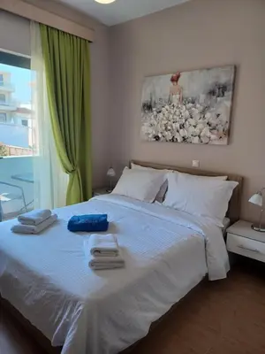 a bedroom with a large bed with towels on it at Melenia Suites in Rhodes Town