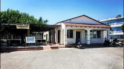 a small building with a sign in front of it at Paradise Studios in Faliraki
