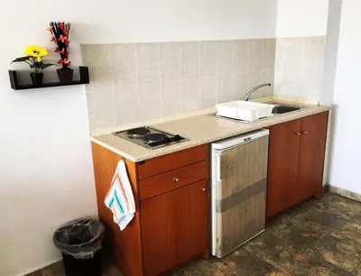 a small kitchen with a sink and a stove at Paradise Studios in Faliraki