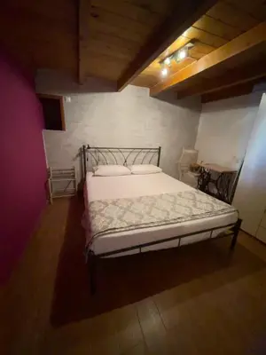 a bedroom with a white bed in a room at Casa Nikolou Halki in Halki