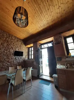 a kitchen and dining room with a table and chairs at Casa Nikolou Halki in Halki