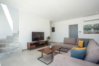 a living room with a couch and a table at Your House In Rhodes in Afantou
