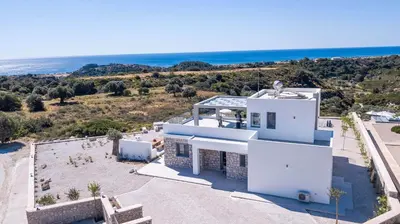 an aerial view of a white house with the ocean at Your House In Rhodes in Afantou