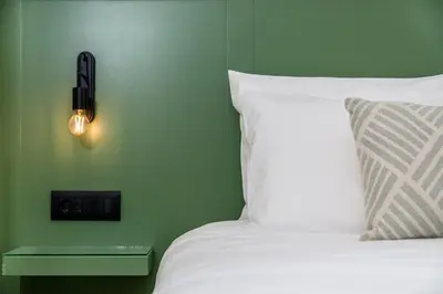 a bedroom with a bed with a light on the wall at Suite Christina in Symi