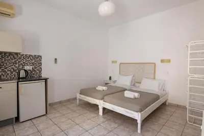 a bedroom with a bed with towels on it at Pefkos View Apartments in Pefki Rhodes