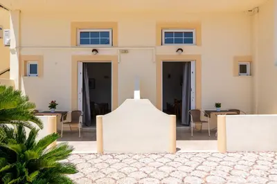 a view of a building with tables and chairs at Pefkos View Apartments in Pefki Rhodes