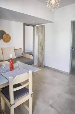a living room with a table and a couch at Joanna Apartments in Haraki