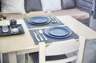 a table with blue plates and utensils on it at Joanna Apartments in Haraki